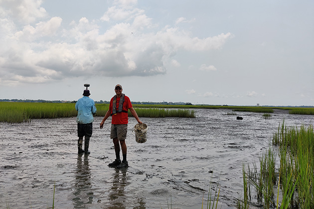 two people walking in a flooded area
