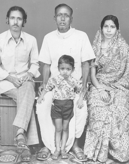 black and white portrait of an Indian family, including one woman, two men, and a male child