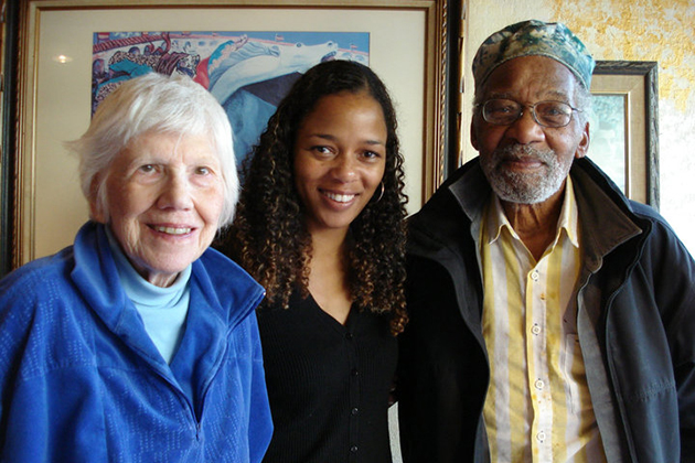 young female standing in the middle of her grandparents