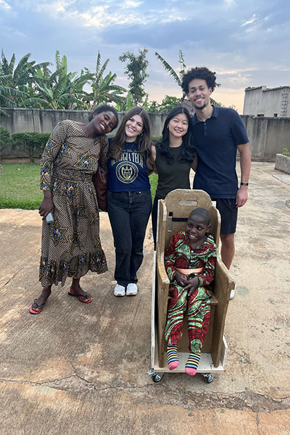 Global AT Innovation VIP students with the chair they designed, alongside the student with a disability and his mother, at the CECHE Foundation in Kayumba, Rwanda.
