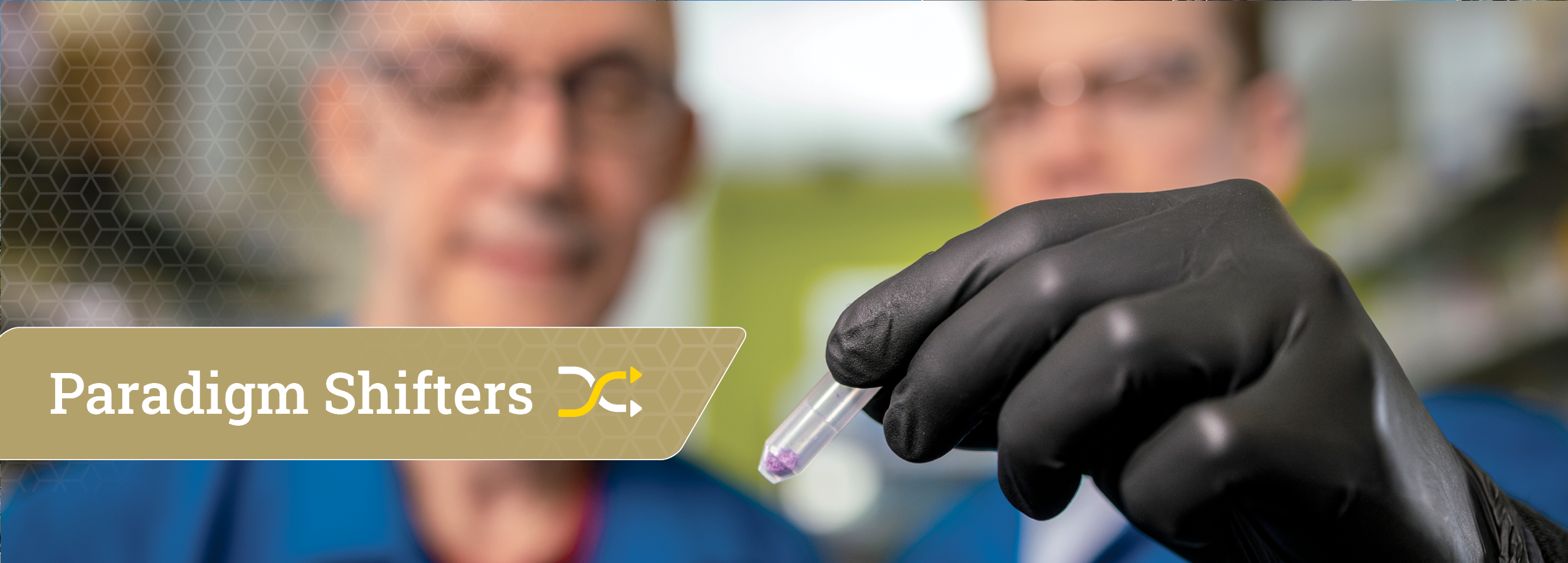 Blurred out image of a scientist showing you a vile with a substance in it in focus. The words Paradigmn Shifters is the title.