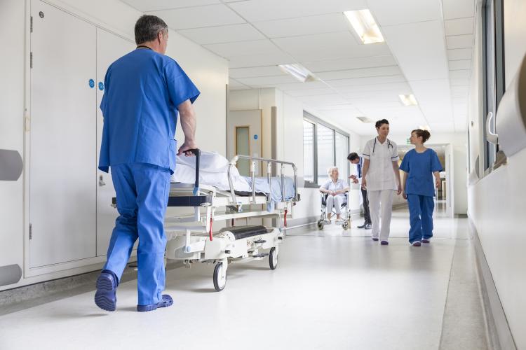 Health care workers in a facility corridor