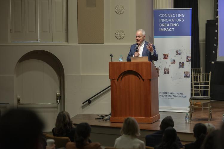 President Ángel Cabrera of Georgia Tech stands at a podium and delivers a speech.