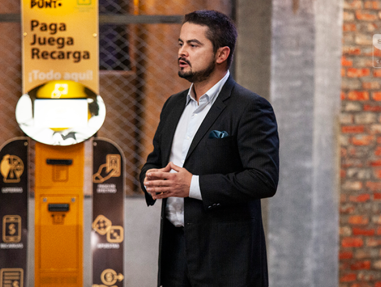 Victor Espinosa, Founder of Loto Punto, stands in front of his product, pitching it on Columbia's Shark Tank