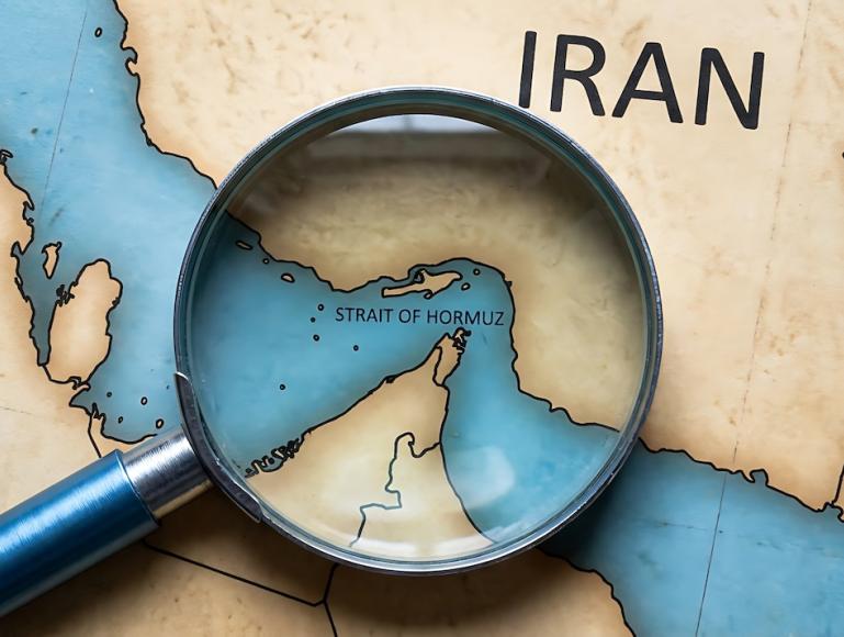 Image of a map of Iran, with a magnifying glass over the Strait of Hormuz