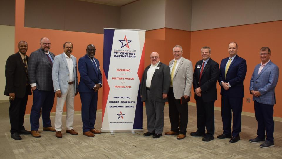 Aaron Stebner, second from left, and Thomas Kurfess, third from right, attending the Robins Regional Chamber’s Eggs and Issues breakfast event on September 8, 2022.