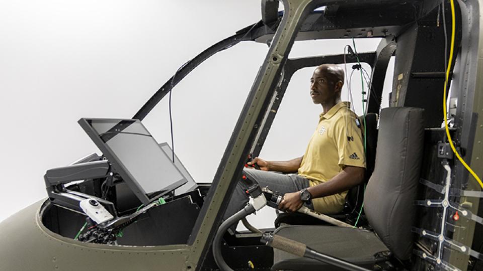 Richard Agbeyibor, Flight Test Engineer, U.S. Air Force, sitting in a space exploration simulator.