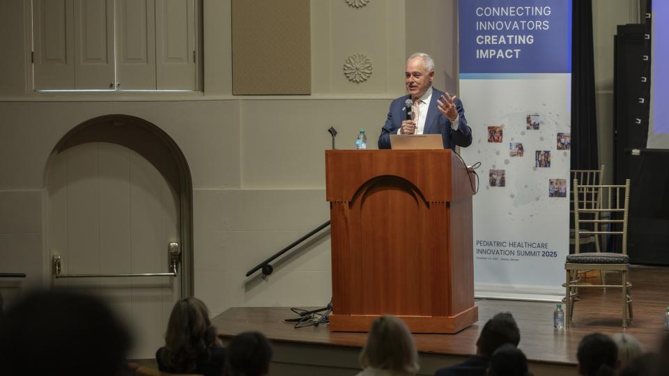 President Ángel Cabrera of Georgia Tech stands at a podium and delivers a speech.