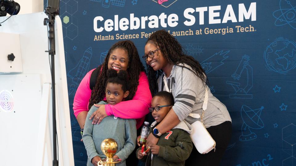 A family poses for a special moment in the Celebrate STEAM photo booth during Georgia Tech's Celebrate STEAM event on March 8.