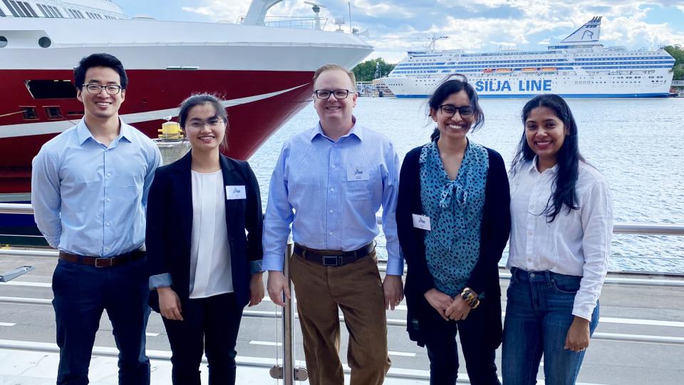 Carson Meredith standing outside in Finland with Georgia Tech Ph.D. students: Yue Ji (ChBE), Li Zhang (MSE), Nasreen Khan (ChBE), and Udita Ringania (ChBE)