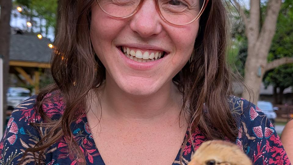 Nicole Kennard holds a young chicken.