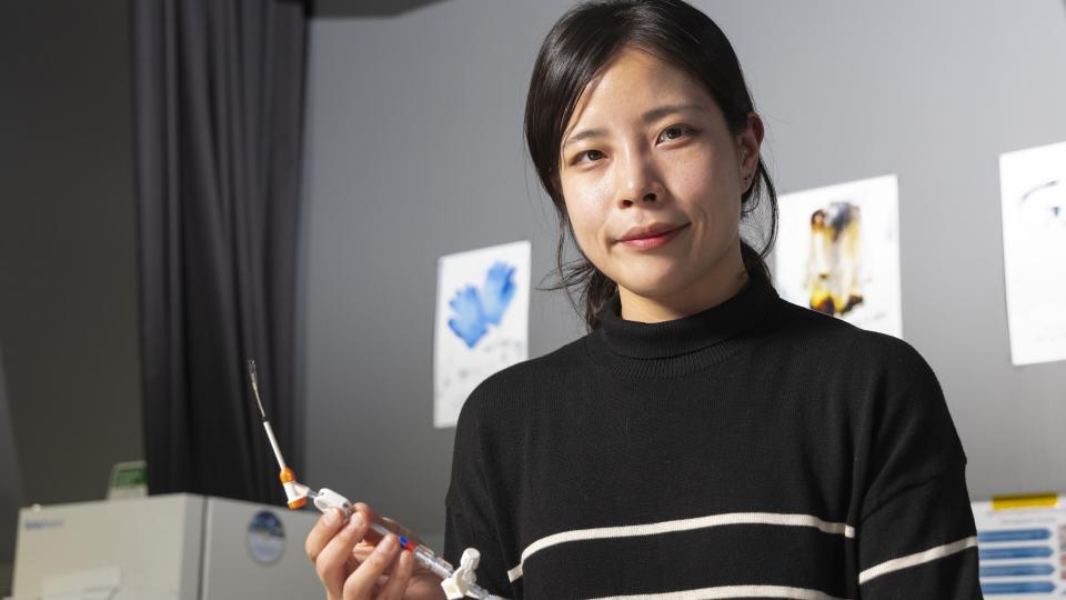 Female researcher in Hong Yeo's lab holding a nanosensor