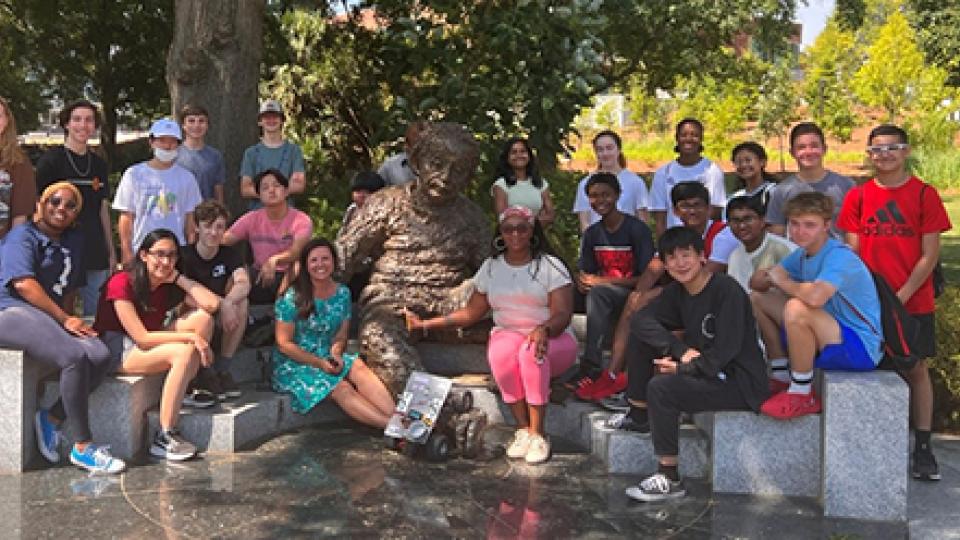 Group photo of the participants of the 2022 Energy Unplugged summer camp on the Georgia Tech Atlanta campus staged around the Einstein bench statue/installation.