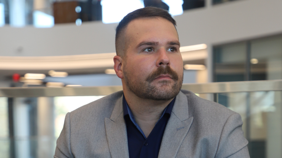 Adam-MacCallum,Jim Pope Fellow and translational research advocate in Georgia Tech’s Wallace H. Coulter Department of Biomedical Engineering, sits pensively, looking out.