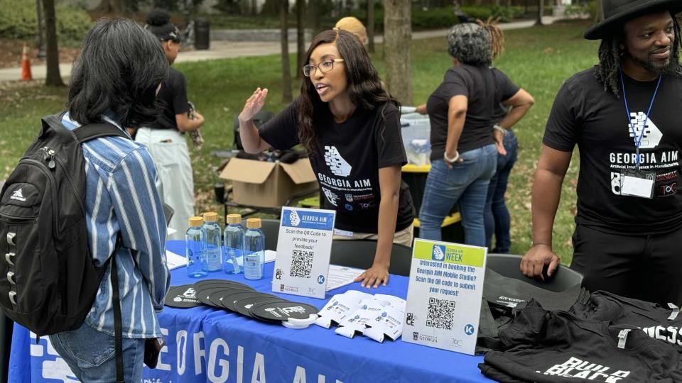 Georgia AIM representatives talk with students on Georgia Tech's campus during the launch event for their new mobile labs.