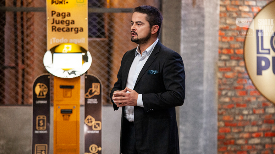 Victor Espinosa, Founder of Loto Punto, stands in front of his product, pitching it on Columbia's Shark Tank