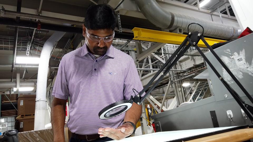 This image shows Sean Madhavaraman, one of the leaders at GaMEP examining work product at Silon in Peachtree City, Georgia.