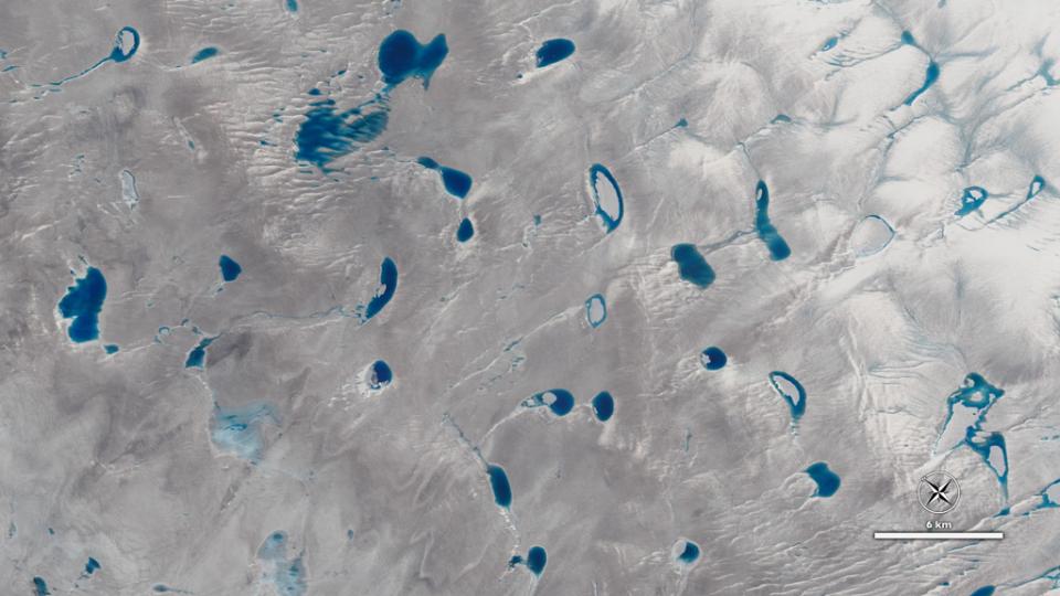 A view of Greenland's ice sheet from the NASA/USGS Landsat 8 satellite showing meltwater lakes on a glacier. (Credit: NASA)