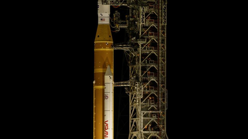 rocket on the launch pad with full moon in background 