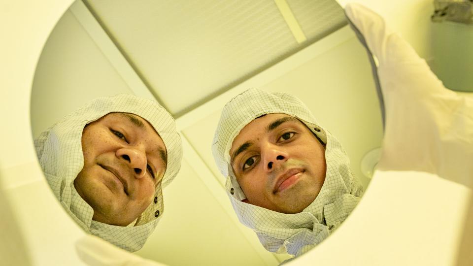 Researchers holding chip