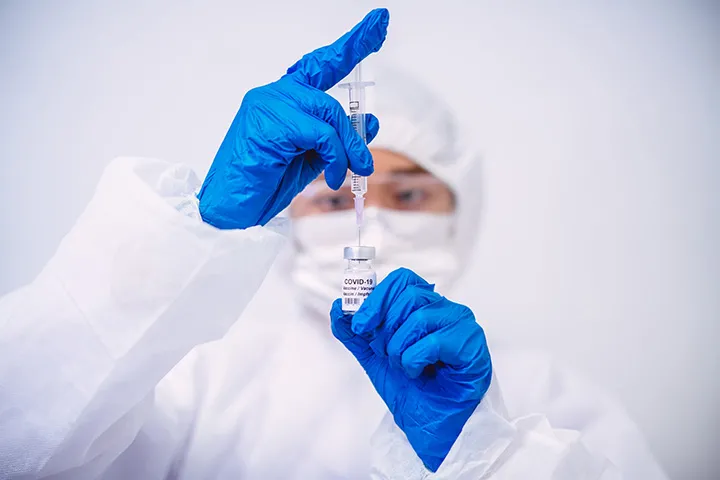 Healthcare worker with vaccine syringe