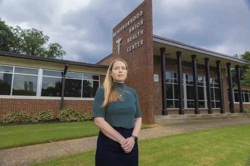 woman standing in front of brick building