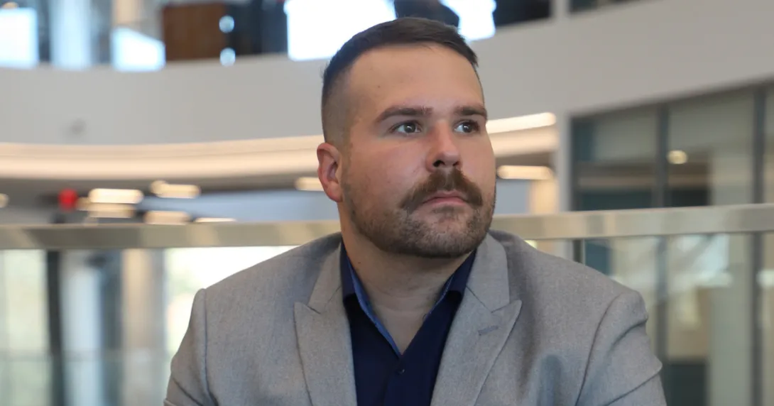 Adam-MacCallum,Jim Pope Fellow and translational research advocate in Georgia Tech’s Wallace H. Coulter Department of Biomedical Engineering, sits pensively, looking out.