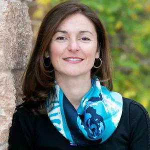 Headshot of woman wearing a blue scarf
