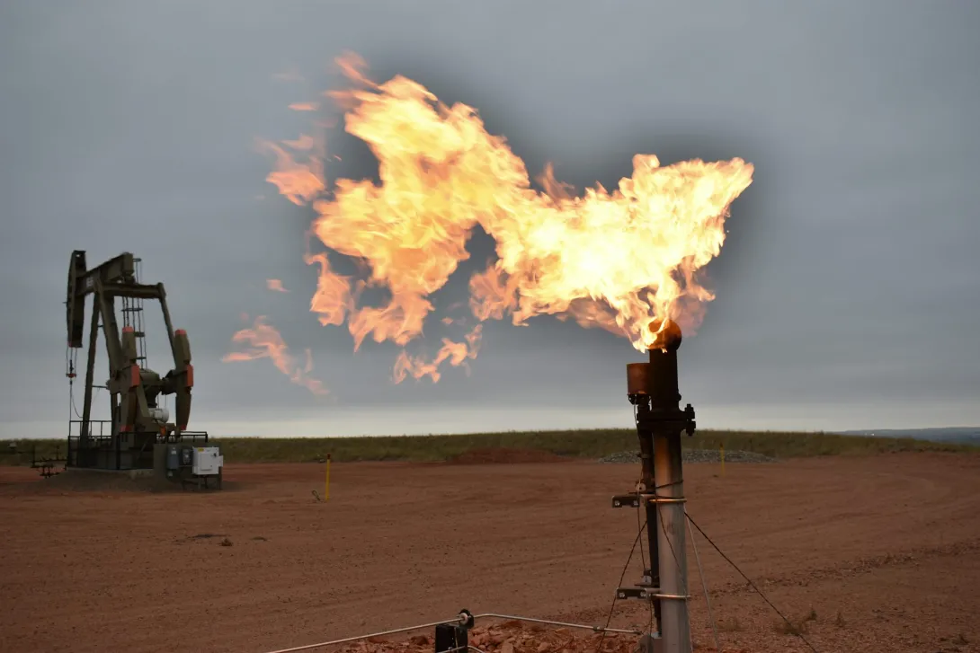 A flare burns natural gas at an oil well on Aug. 26, 2021, in Watford City, N.D. 
