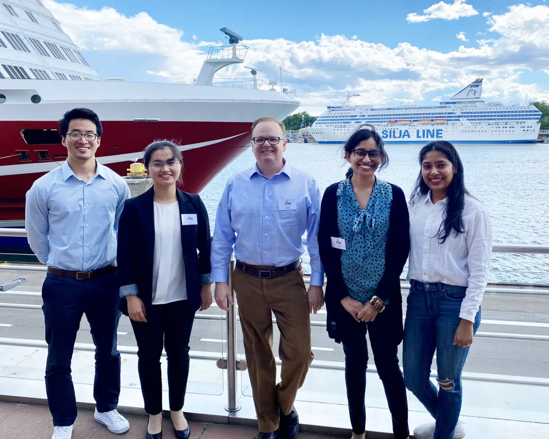 Carson Meredith standing outside in Finland with Georgia Tech Ph.D. students: Yue Ji (ChBE), Li Zhang (MSE), Nasreen Khan (ChBE), and Udita Ringania (ChBE)