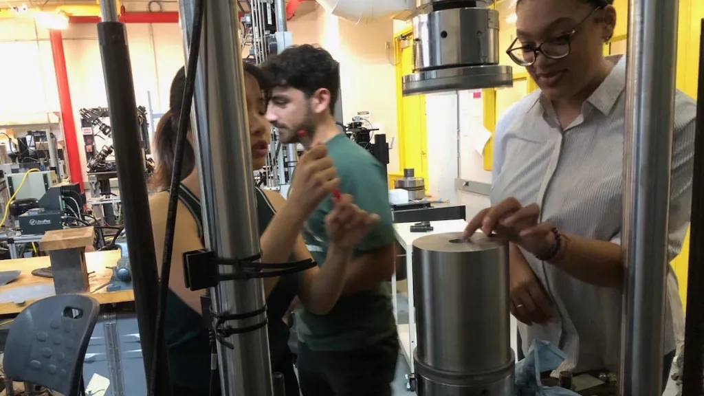 Biomedical Engineering graduate students work on their custom hydraulic press