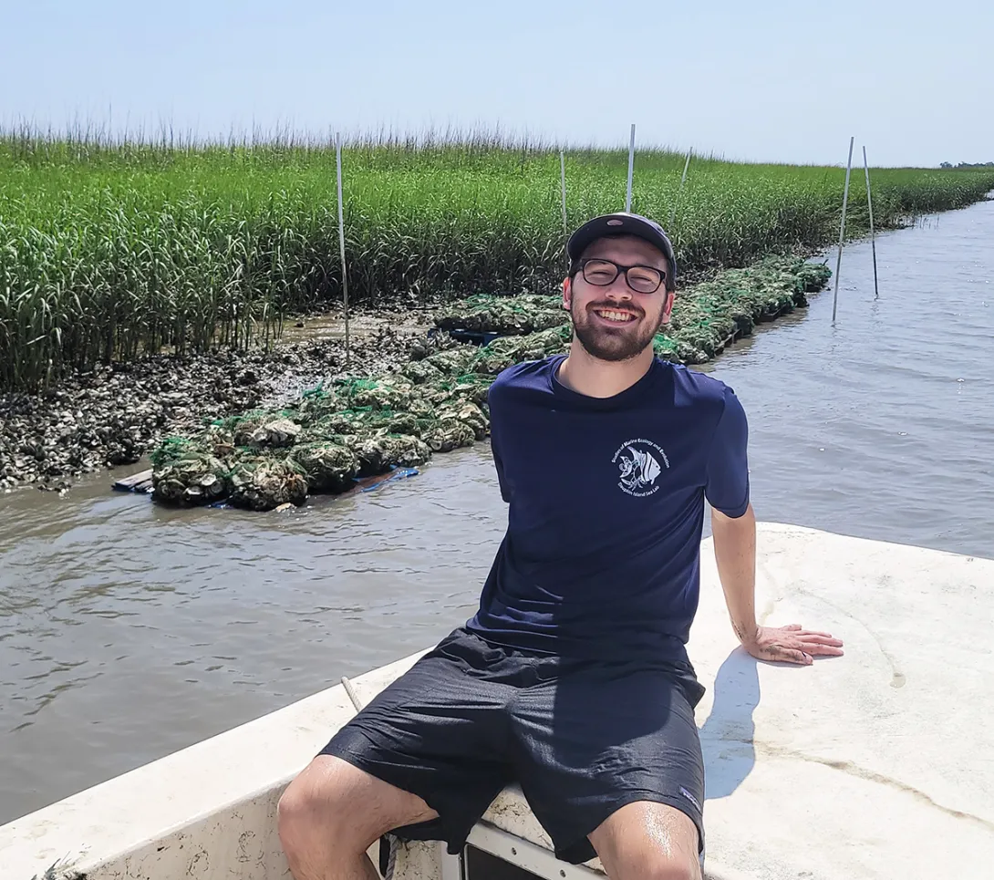 Tanner Lee (Georgia Tech, BS Biology '23) helped construct the oyster reef he observes from a boat as part of an undergraduate research project.