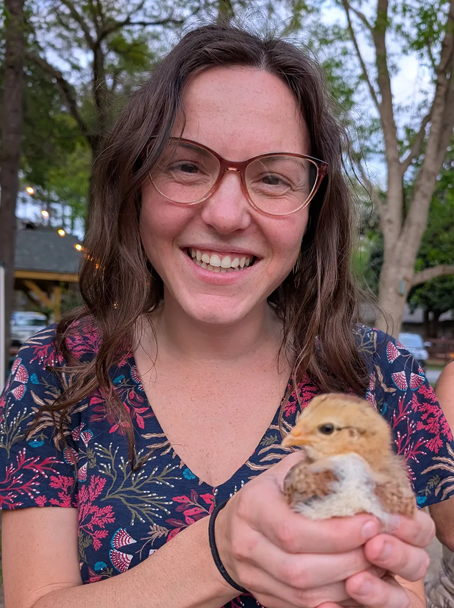Nicole Kennard holds a young chicken.