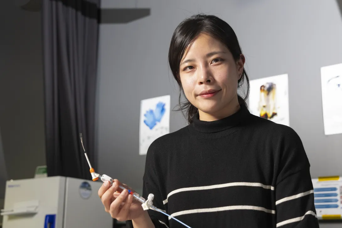 Female researcher in Hong Yeo's lab holding a nanosensor